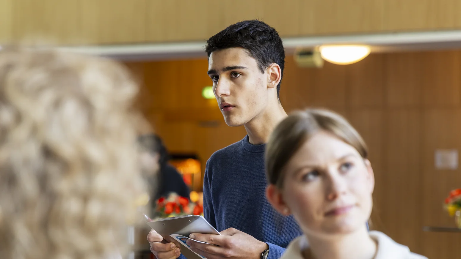 Ein interessierter Student, der auf seine Notizen blickt.
